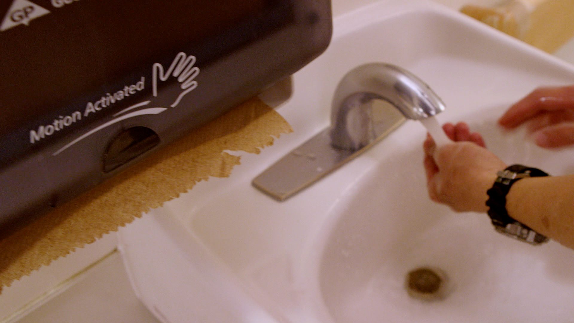 person obeying the wash your hands sign