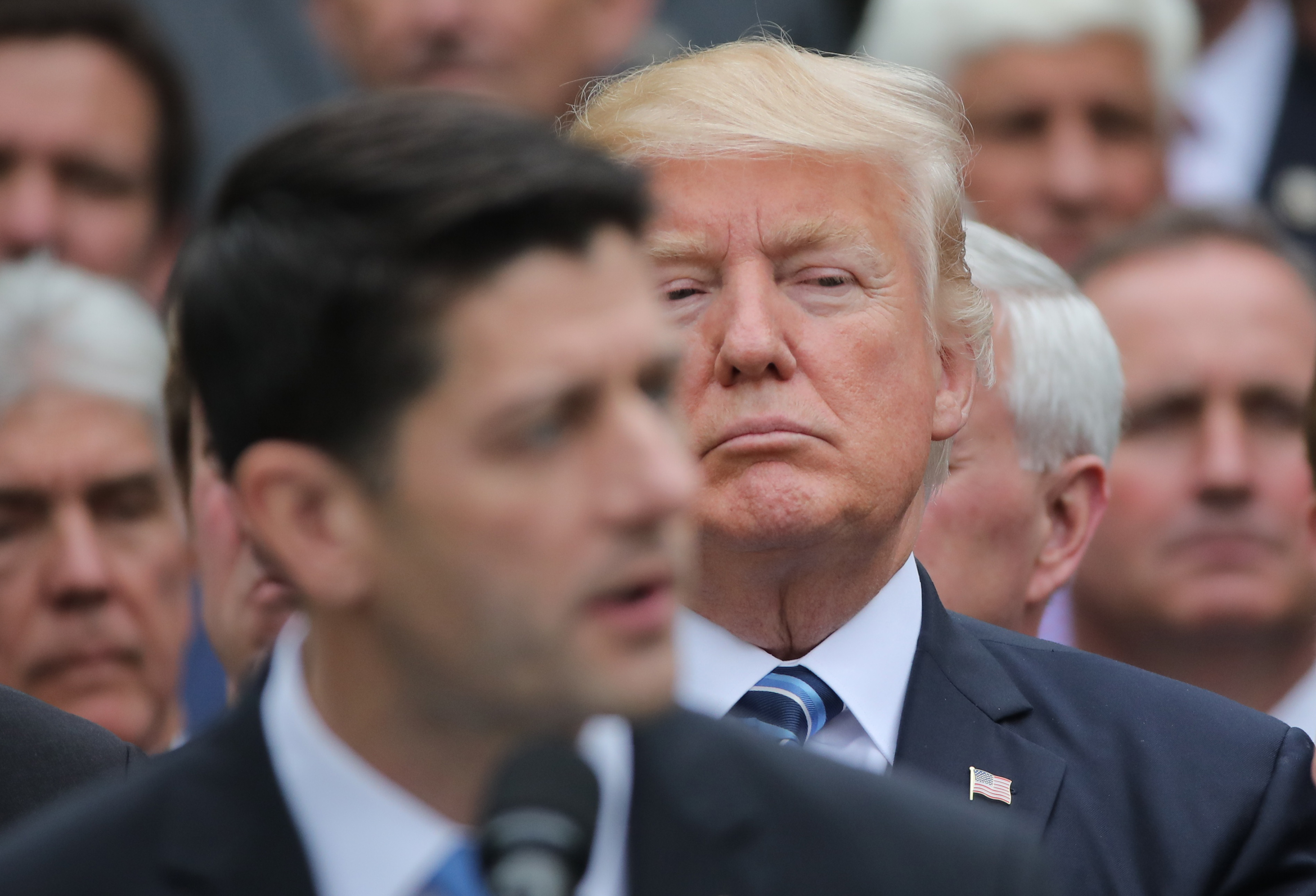 U.S. President Trump listens to  Speaker Ryan as he gathers with Republican House members after healthcare bill vote at the White House in Washington