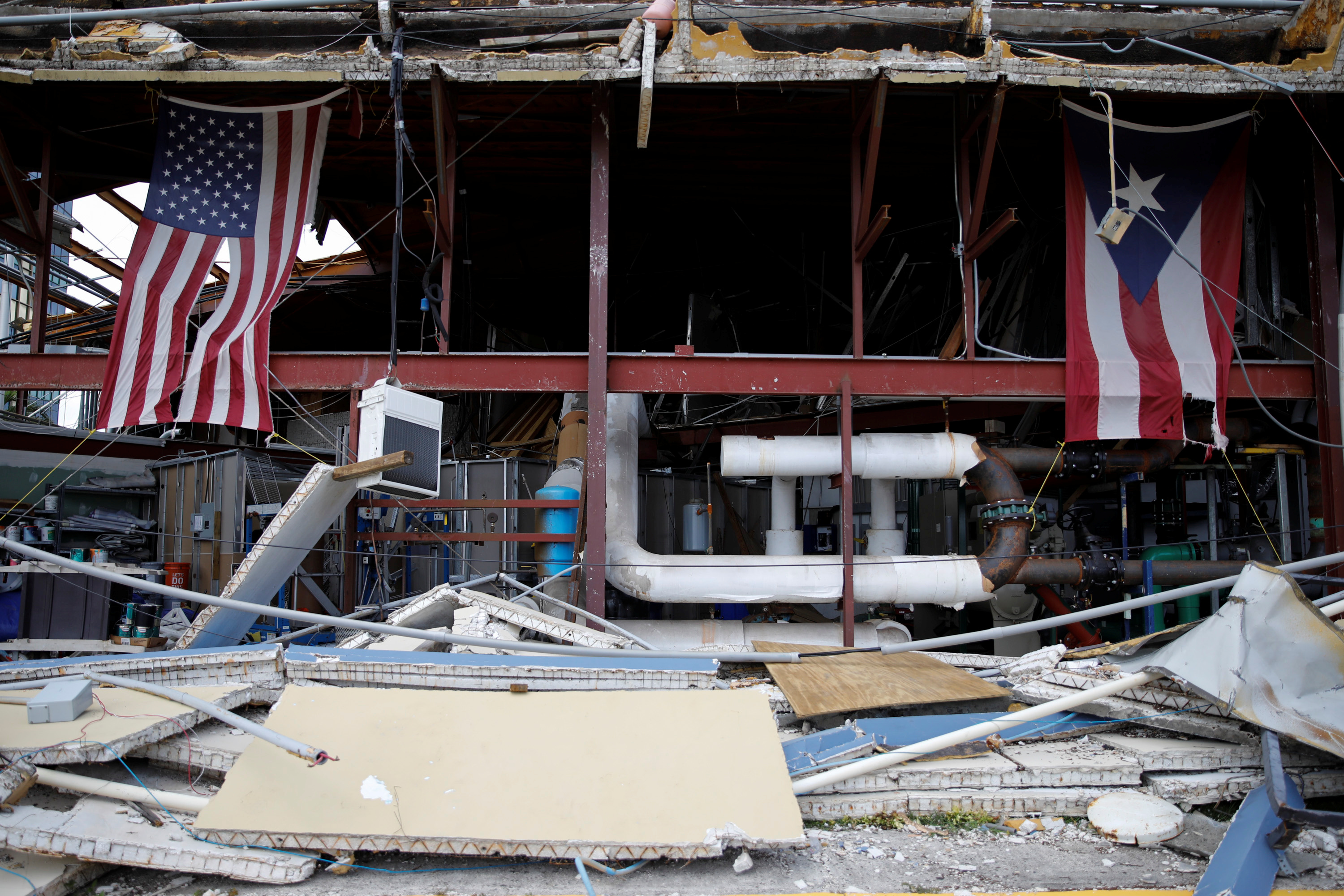 U.S. and Puerto Rico flags hang on a damaged church after the area was hit by Hurricane Maria in Carolina
