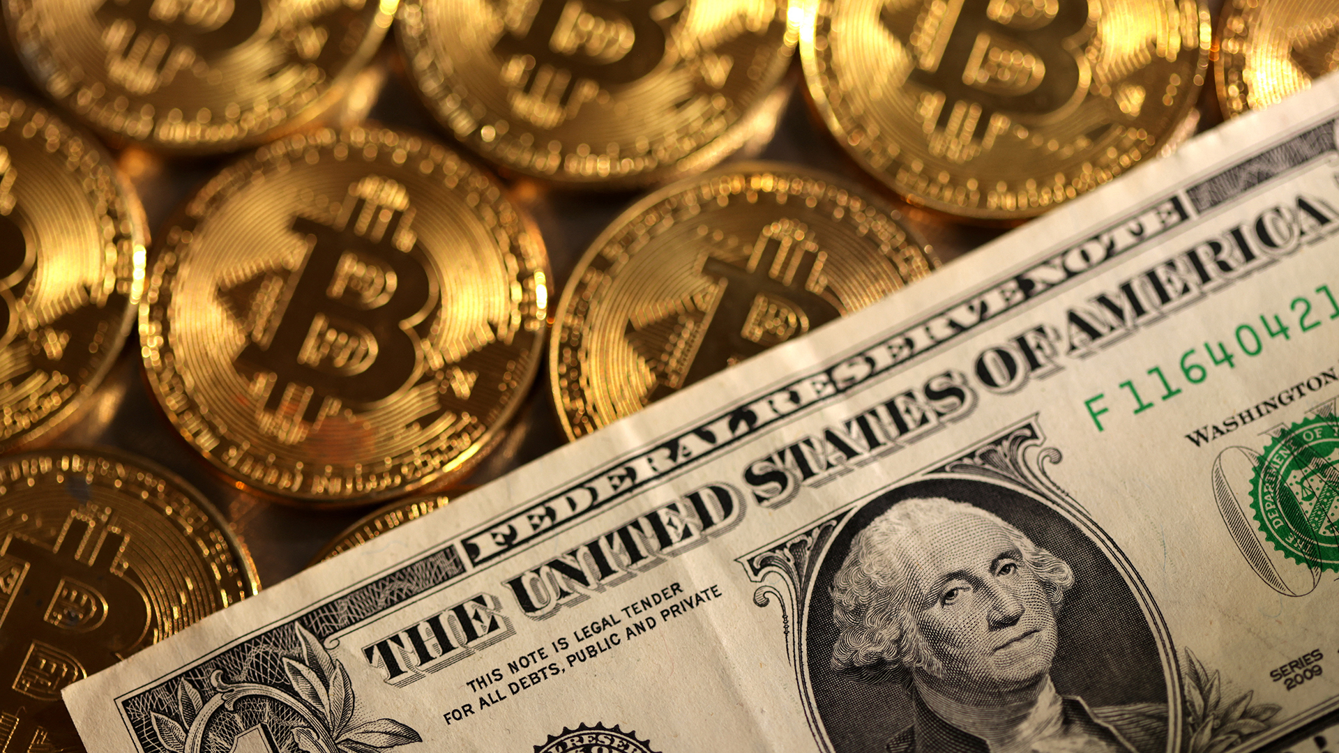 Illustration shows representations of cryptocurrency Bitcoin and U.S. dollar